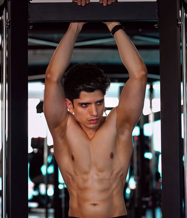 Man performing a strength training exercise with focus and determination.